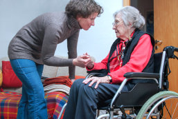 female caregiver helping senior woman