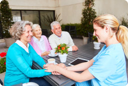 caregiver and group of seniors talking