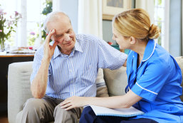 caregiver talking to senior man