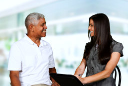 senior man and female caregiver talking