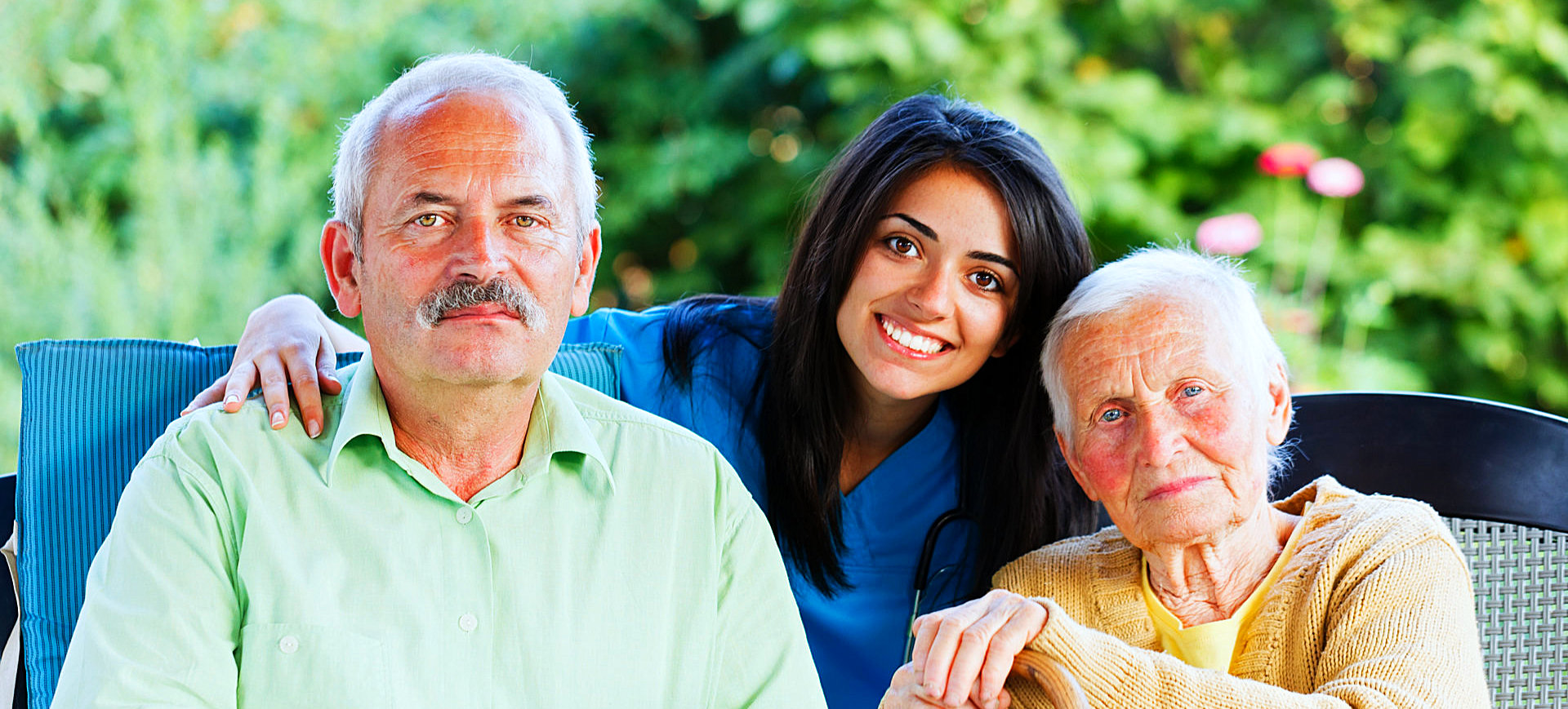 senior couple with their female caregiver